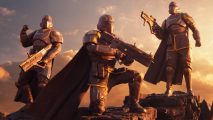 Helldivers 2 dev apologizes for going " a little far" with Reddit troll: A character in combat gear with a black skin waving in the wind, kneeling on one knee on top of a pile of dirt as the sun sets in the background, two other players behind them